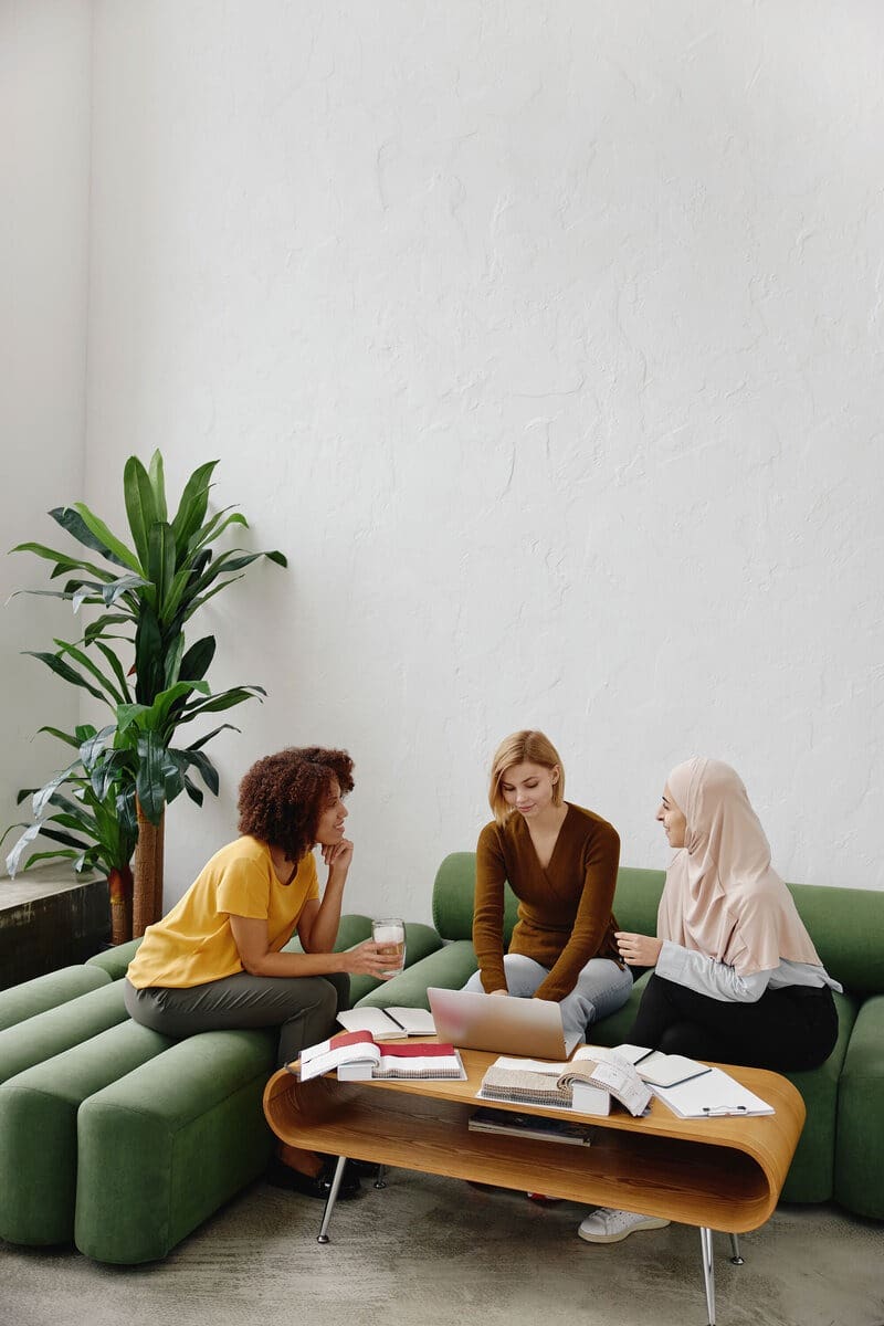 Women sit together and discuss the strategy from running a law firm and an advisory practice at the same time