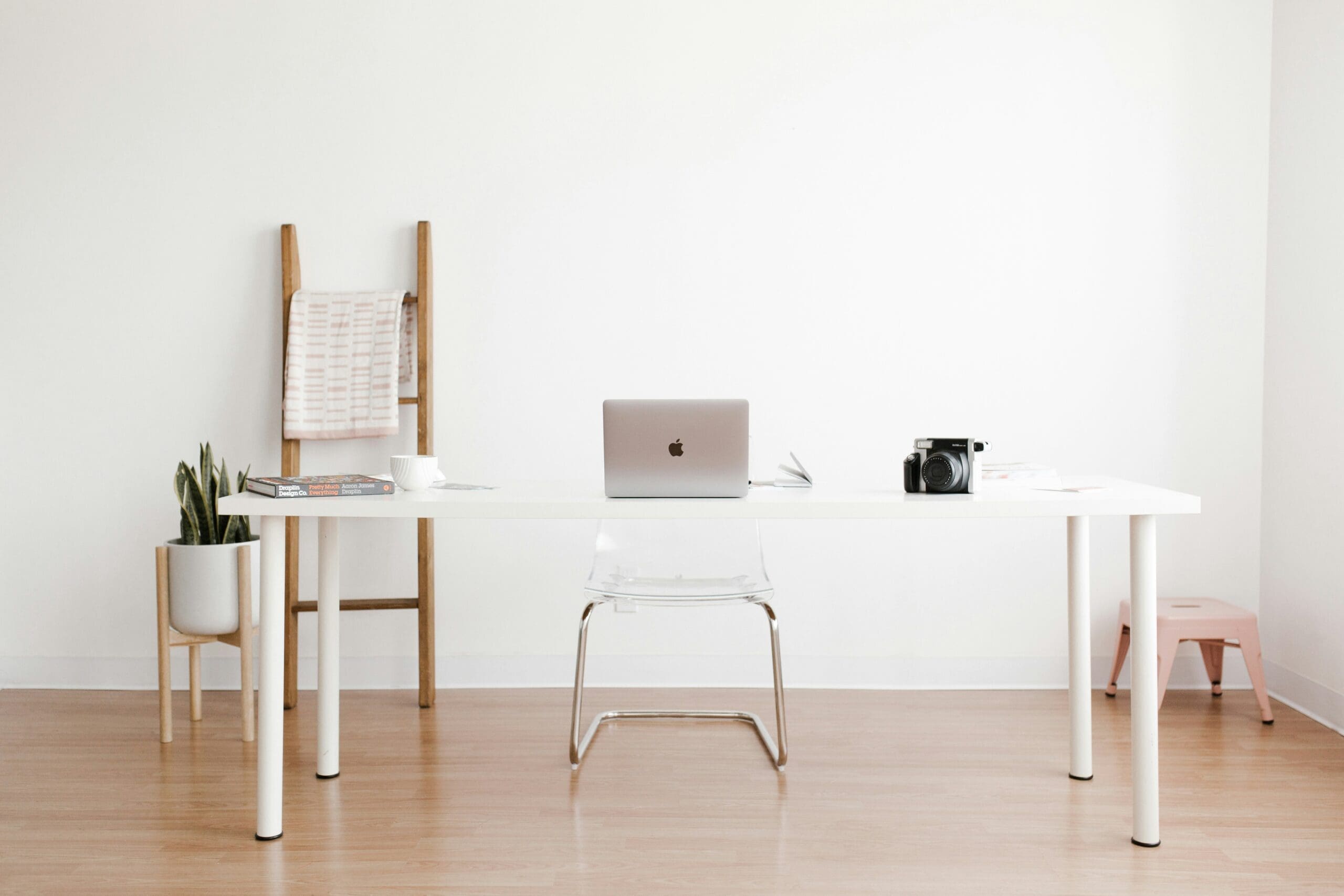 Decorated neutral desk space where a person is ready to discuss when your business has outgrown its strategy